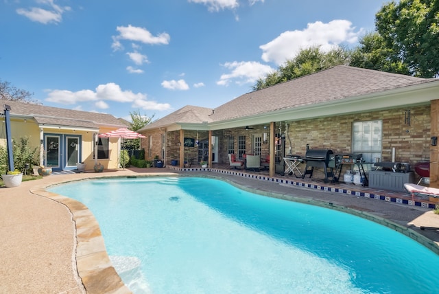 view of swimming pool with a patio and area for grilling