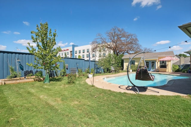 view of swimming pool with a lawn