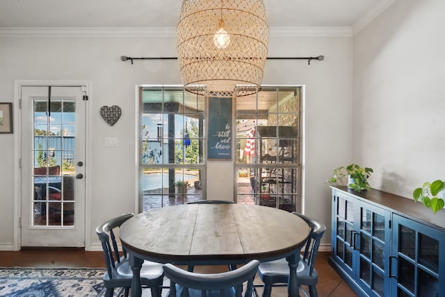 tiled dining space featuring a chandelier, crown molding, and a healthy amount of sunlight