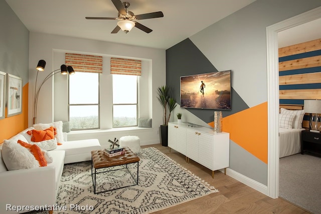 living room with ceiling fan and light hardwood / wood-style floors