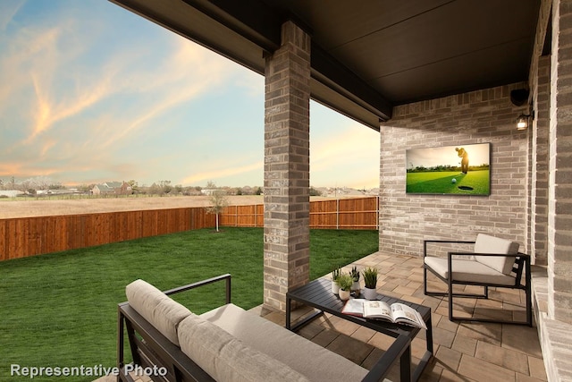 patio terrace at dusk with a yard and outdoor lounge area