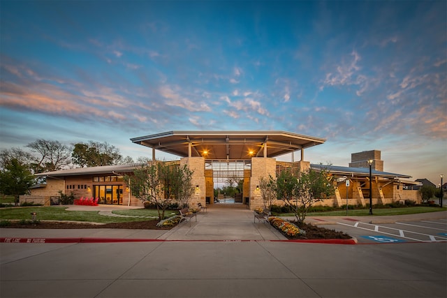 view of outdoor building at dusk