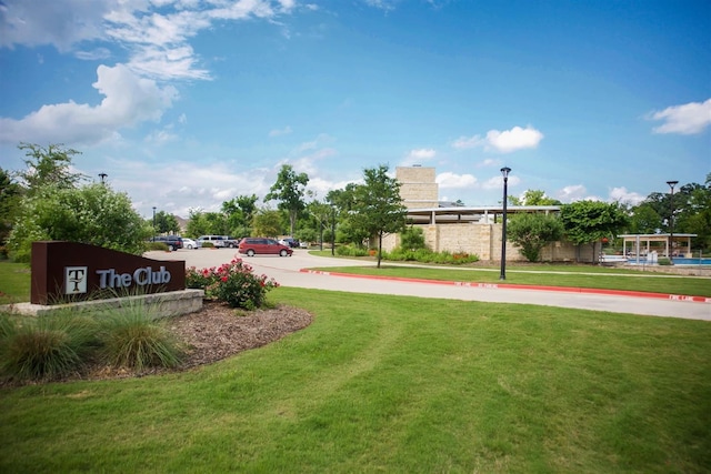 view of property's community with a lawn