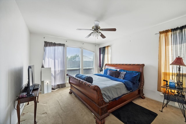 bedroom featuring light colored carpet and ceiling fan