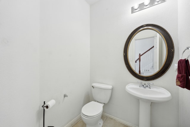 bathroom featuring toilet and tile patterned flooring