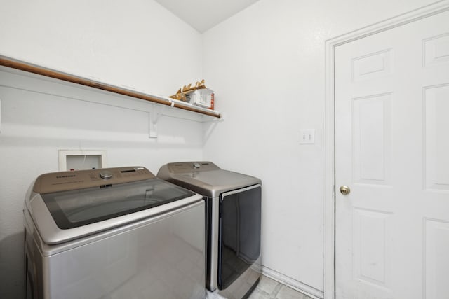 clothes washing area with washing machine and clothes dryer