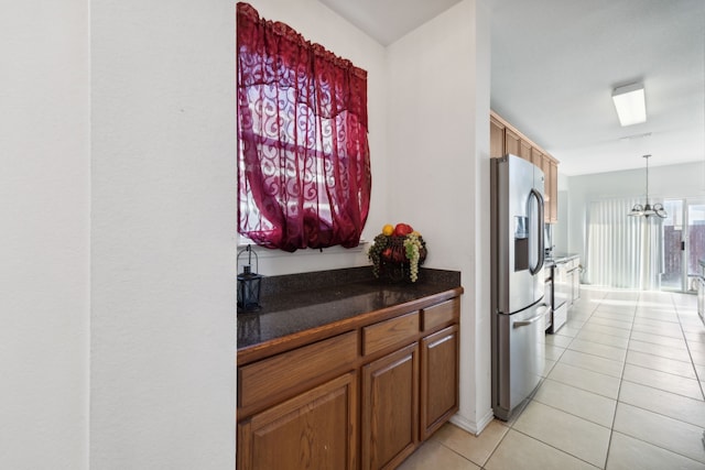 kitchen featuring stainless steel fridge with ice dispenser, light tile patterned floors, decorative light fixtures, and a notable chandelier