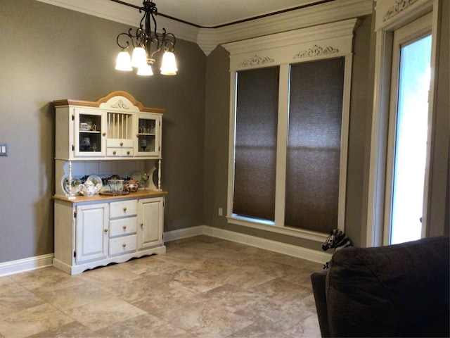 dining area featuring an inviting chandelier and ornamental molding