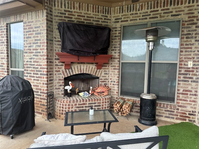 view of patio with a fireplace and grilling area