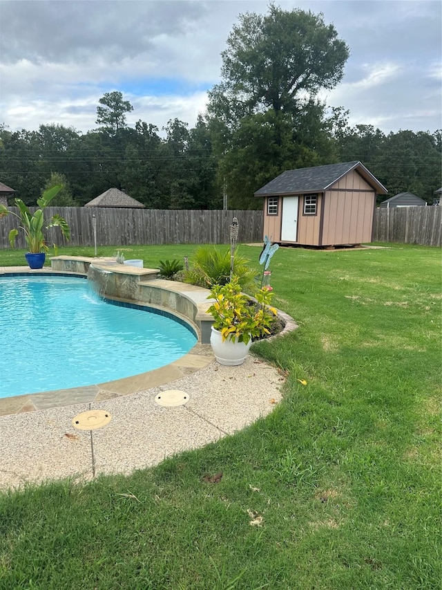 view of swimming pool featuring pool water feature, a shed, and a lawn