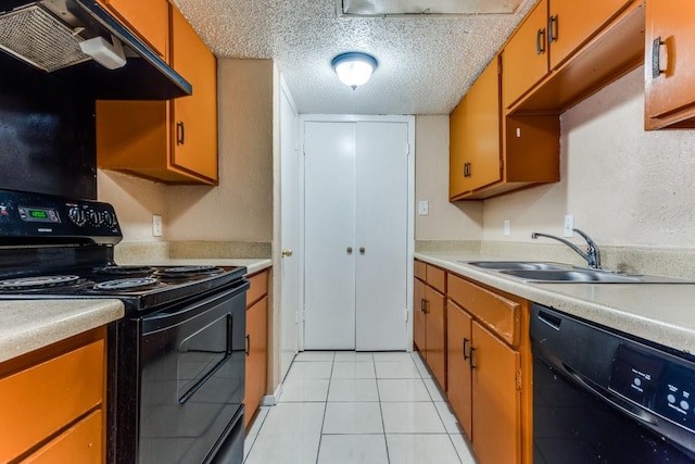 kitchen featuring black appliances, under cabinet range hood, light countertops, a textured ceiling, and a sink