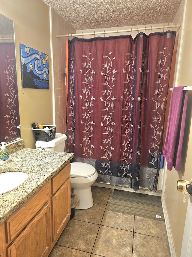 full bathroom featuring tile patterned flooring, toilet, shower / tub combo with curtain, vanity, and a textured ceiling