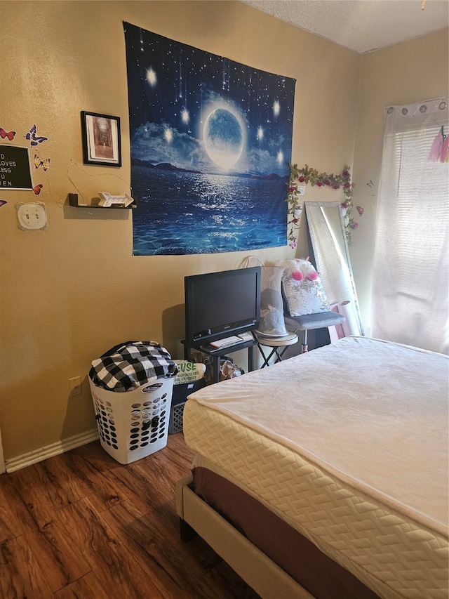 bedroom with hardwood / wood-style flooring