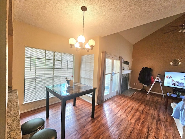 dining space featuring high vaulted ceiling, dark hardwood / wood-style floors, an inviting chandelier, and a textured ceiling