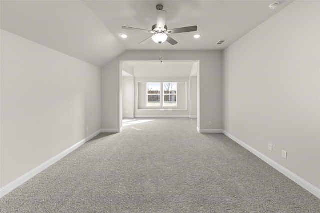 carpeted empty room with ceiling fan and lofted ceiling