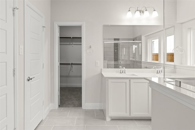 bathroom with vanity, tile patterned flooring, and a shower with door