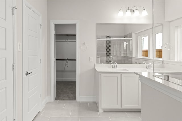 3504 Verbena Xing, Melissa, TX 75454 - bathroom featuring a shower stall, vanity, tile patterned floors, a walk in closet, and baseboards