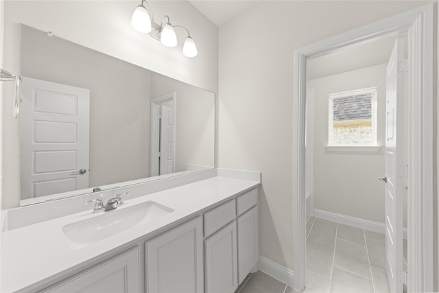 bathroom featuring vanity, tile patterned floors, and a tub to relax in