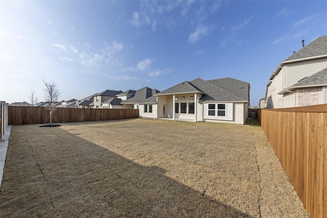 rear view of property featuring a yard