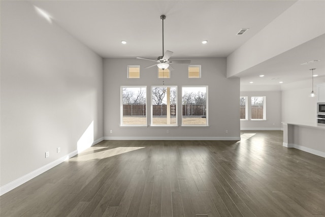 interior space with dark wood-type flooring and ceiling fan