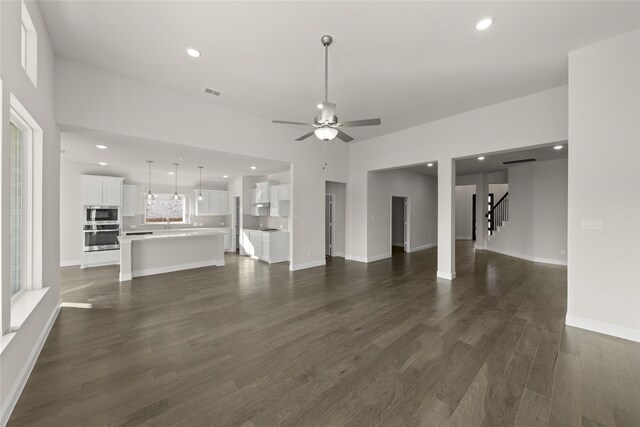 3504 Verbena Xing, Melissa, TX 75454 - unfurnished living room with a ceiling fan, dark wood-style flooring, stairs, recessed lighting, and baseboards