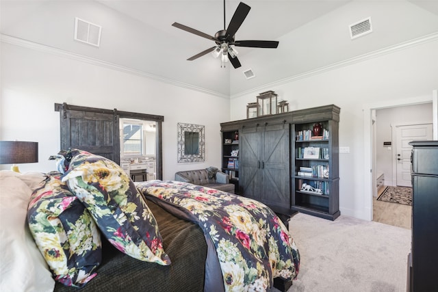 carpeted bedroom featuring a barn door, visible vents, and vaulted ceiling