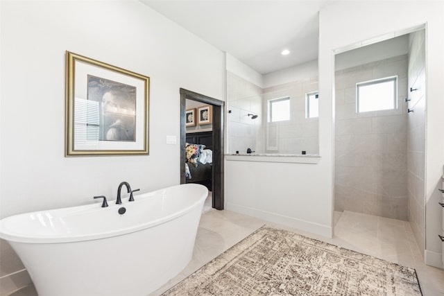 bathroom featuring recessed lighting, a soaking tub, walk in shower, and tile patterned flooring