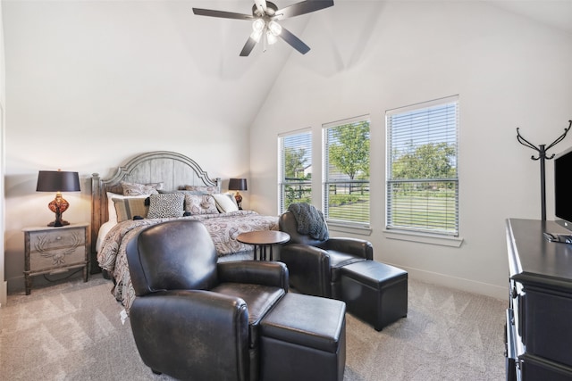 bedroom with baseboards, light carpet, high vaulted ceiling, and ceiling fan