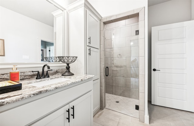 full bathroom with vanity, a shower stall, and tile patterned floors