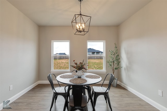 dining area featuring an inviting chandelier and light hardwood / wood-style floors