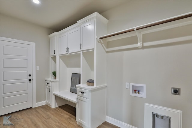 clothes washing area with washer hookup, cabinets, light wood-type flooring, and hookup for an electric dryer