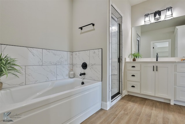 bathroom with vanity, hardwood / wood-style floors, and separate shower and tub