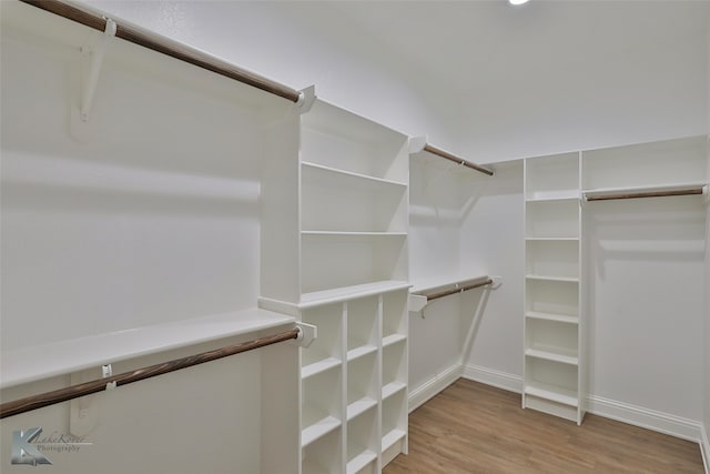 walk in closet featuring light hardwood / wood-style flooring