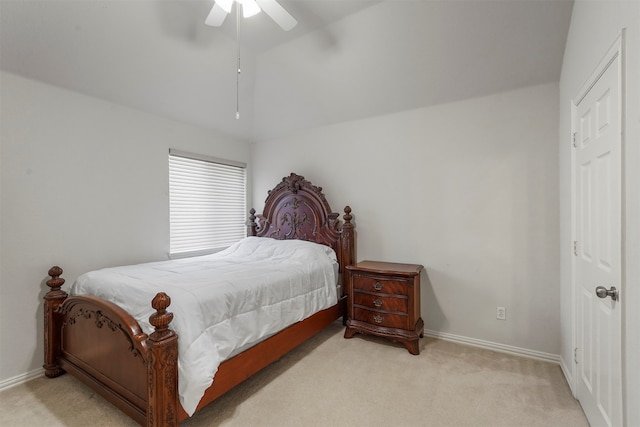 carpeted bedroom with ceiling fan and vaulted ceiling