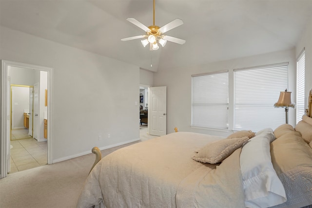 carpeted bedroom featuring ensuite bath, ceiling fan, and vaulted ceiling