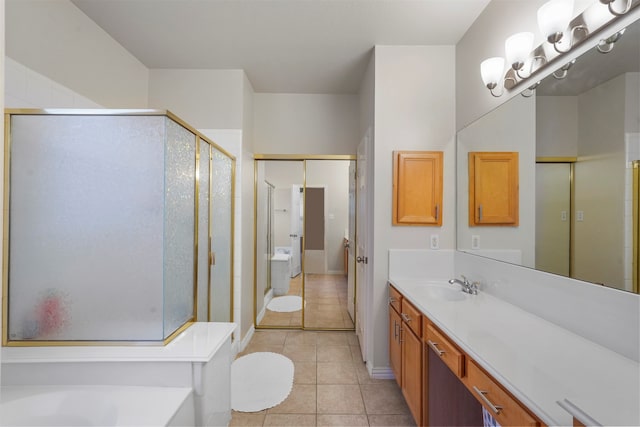 bathroom with tile patterned flooring, vanity, and separate shower and tub