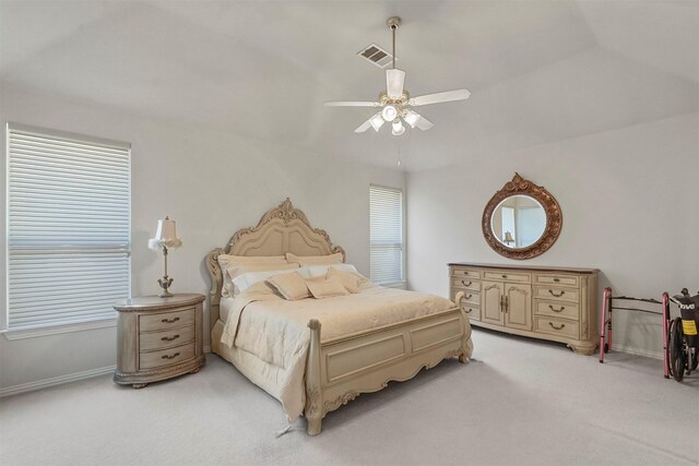 bedroom with lofted ceiling, ceiling fan, and light carpet