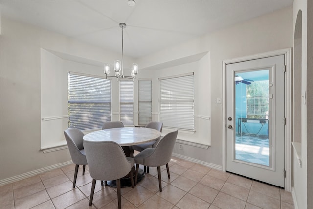 dining area featuring a notable chandelier and light tile patterned flooring