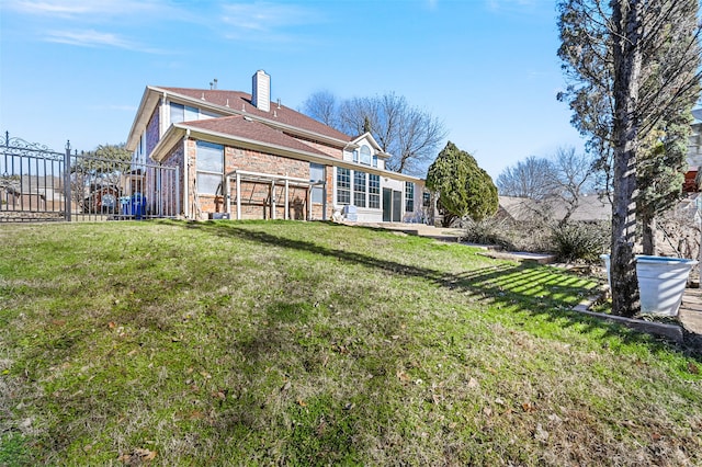 rear view of property featuring a yard