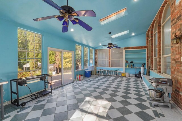 sunroom with vaulted ceiling with skylight and ceiling fan