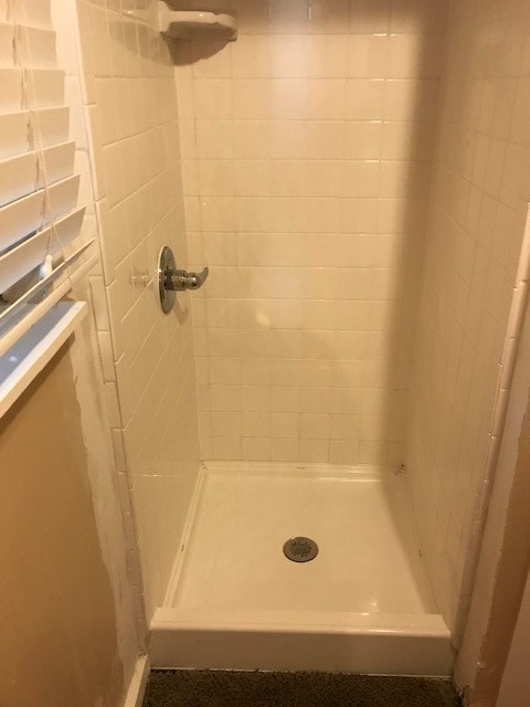 bathroom with a tile shower