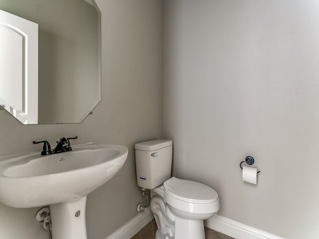 bathroom with toilet and tile patterned floors