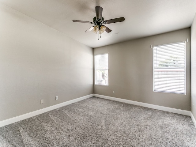 carpeted spare room featuring ceiling fan