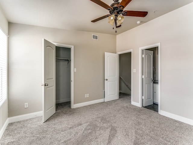 unfurnished bedroom with ceiling fan and light colored carpet