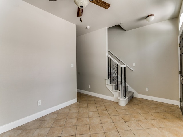 empty room with light tile patterned flooring and ceiling fan