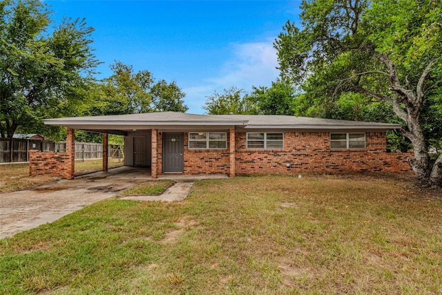 ranch-style house featuring a front yard and a carport