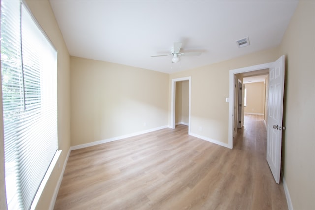 unfurnished bedroom with ceiling fan and light hardwood / wood-style floors