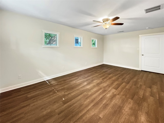 spare room with ceiling fan and dark wood-type flooring