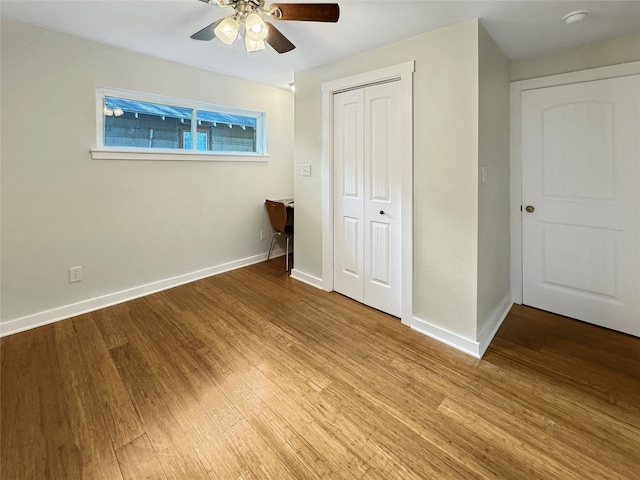 unfurnished bedroom featuring ceiling fan, a closet, and light hardwood / wood-style flooring