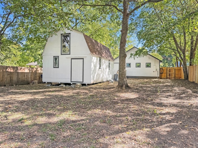 exterior space with cooling unit and a storage shed